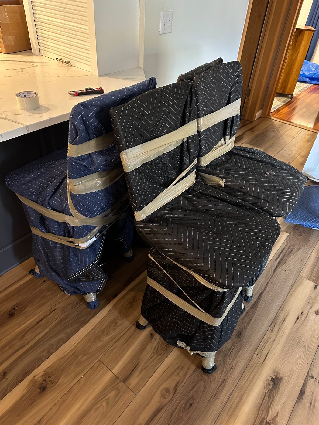 Kitchen chairs wrapped in moving blankets before transport for a Chicago to Wheeling move