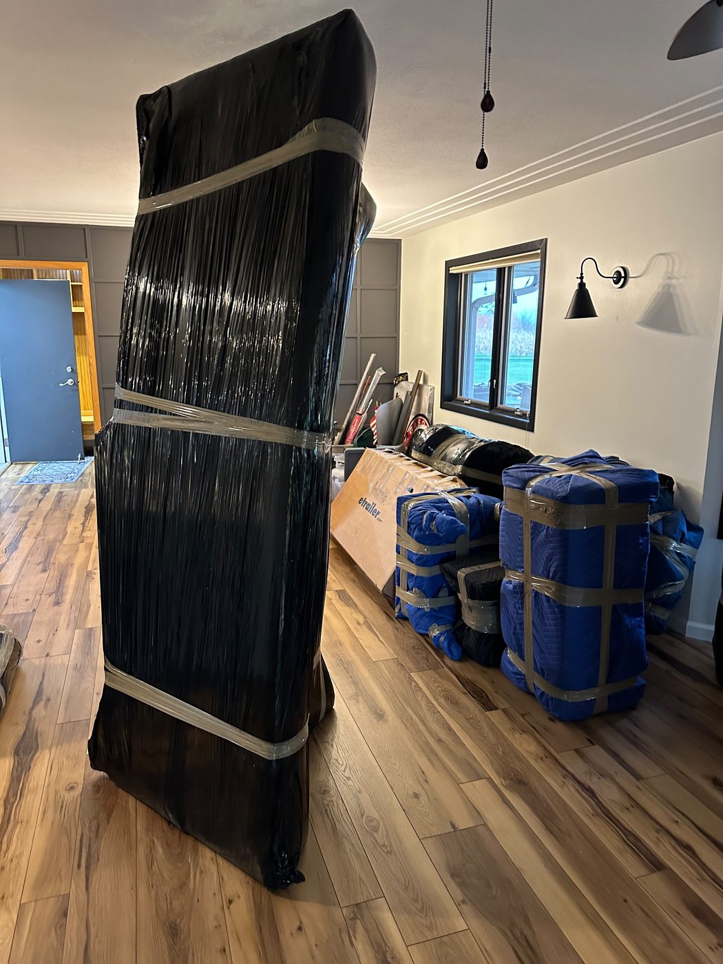 Living-room furniture wrapped for a cross-country haul for a Chicago to Warwick move